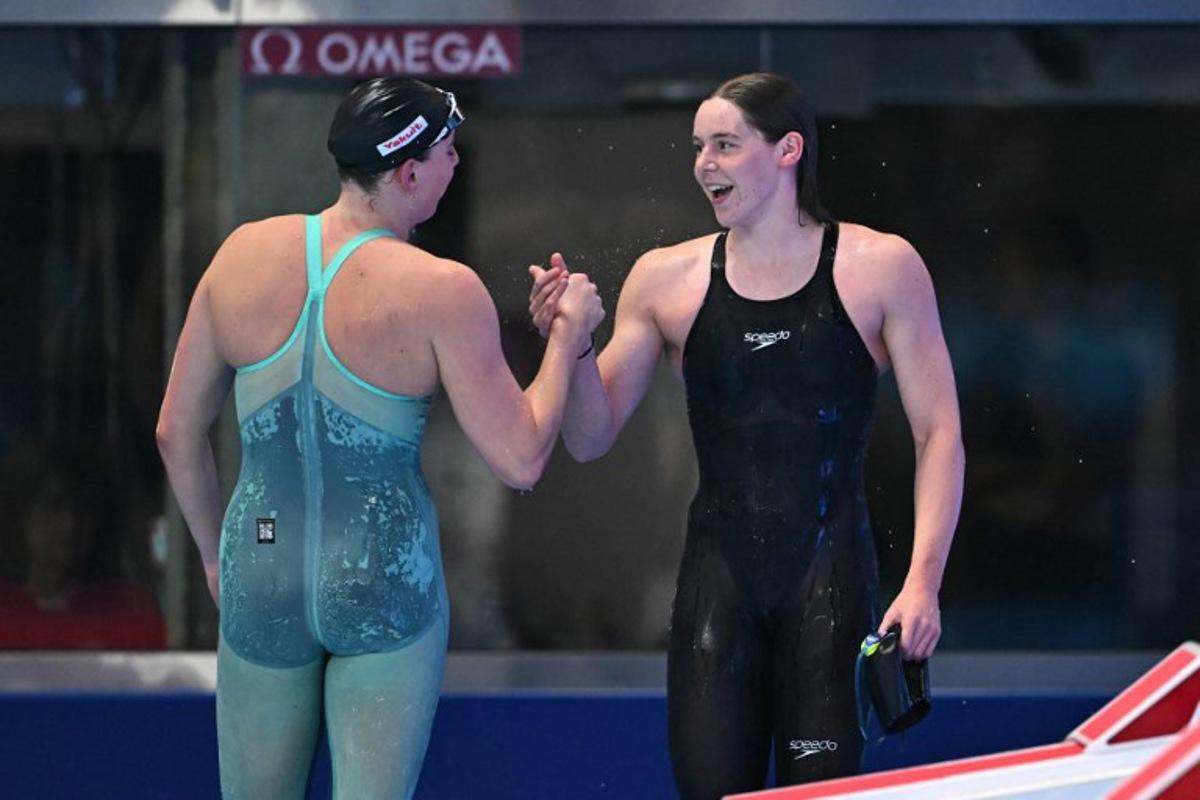 Belgium's swimmer Roos Vanotterdijk (R) reacts after a semi-final of the women's 50m butterfly swimming event during the 2025 World Aquatics Championships in Singapore on August 1, 2025. MANAN VATSYAYANA / AFP