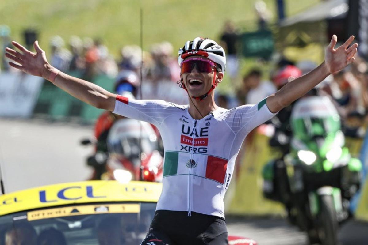 UAE Team Emirates XRG's Mexican rider Isaac Del Toro Romero celebrates as he cycles to the finish line to win the 8th and final stage of the Tour Auvergne-Rhone-Alpes cycling race (formerly known as the Criterium du Dauphine), 120,1km between Beaufort and Plateau de Solaison, in the French Alps on June 14, 2026. Anne-Christine POUJOULAT / AFP