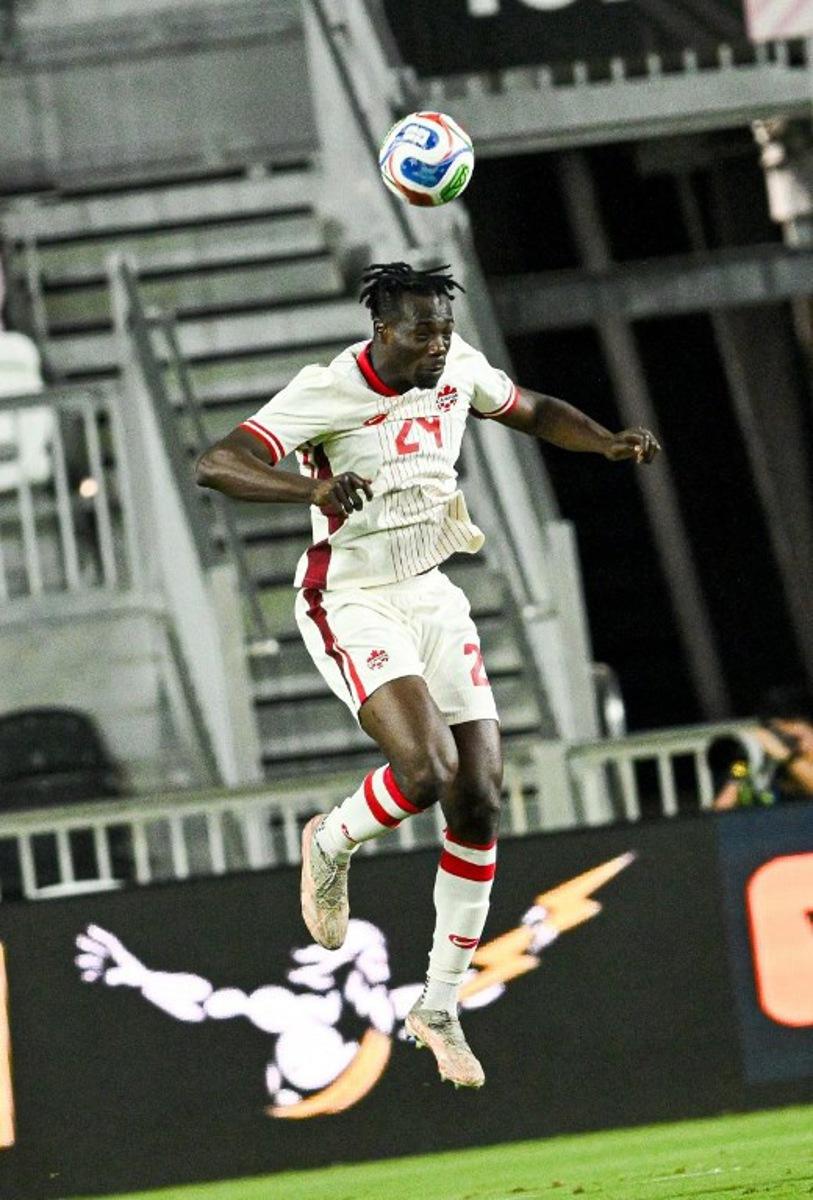 Canada's forward #24 Promise David heads the ball during the international friendly football match between Canada and Venezuela at Chase Stadium in Fort Lauderdale, Florida, on November 18, 2025. CHANDAN KHANNA / AFP