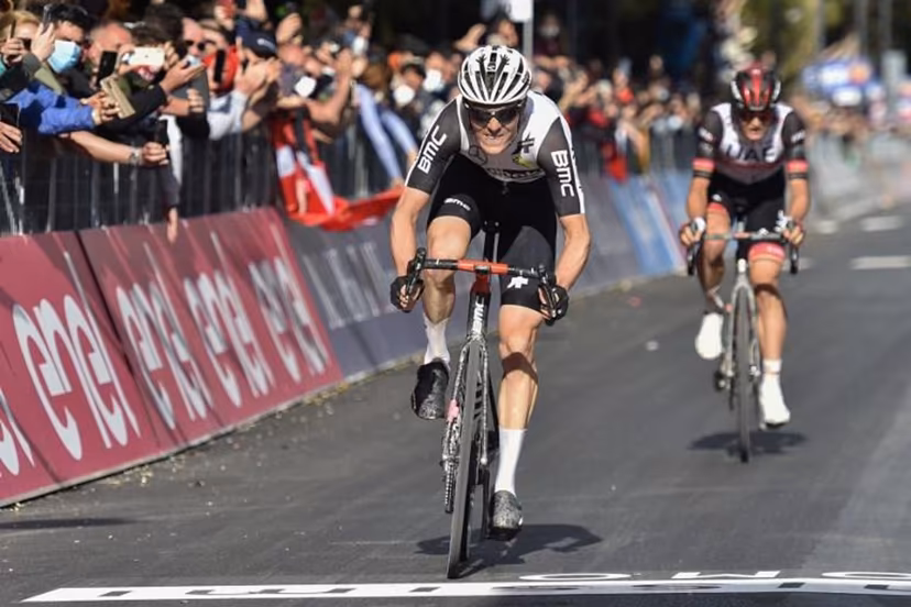 Team Qhubeka Assos rider Switzerland's Mauro Schmid (C) followed by Team UAE Emirates rider Italy's Alessandro Covi, rides to cross the finish line to win the eleventh stage of the Giro d'Italia 2021 cycling race, 162 km between Perugia and Montalcino on May 19, 2021. Tommaso Pelagalli / AFP
