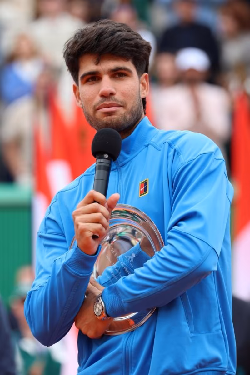 Spain's Carlos Alcaraz delivers a speech as he celebrates second place on the podium after the Monte Carlo ATP Masters Series Tournament final tennis match against Italy's Jannik Sinner on Court Rainier III at the Monte-Carlo Country Club in Roquebrune-Cap-Martin, south-eastern France on April 12, 2026. Valery HACHE / AFP