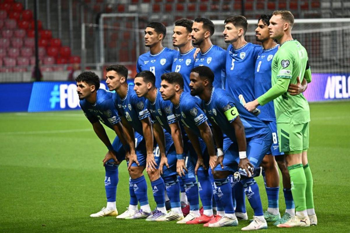 Israeli players (L to R Bottom) Israel's defender #03 Roy Revivo, Israel's midfielder #20 Dan Biton, Israel's midfielder #11 Oscar Gloukh, Israel's forward #10 Manor Solomon and Israel's defender #02 Eli Dasa (over) Israel's forward #13 Anan Khalaili, Israel's defender #12 Stav Lemkin, Israel's midfielder #15 Eliel Peretz, Israel's defender #05 Idan Nachmias, Israel's midfielder #08 Dor Peretz and Israel's goalkeeper #01 Daniel Peretz pose for a team photo prior to the 2026 World Cup qualifiers Europe zone group I football match between Israel and Italy on September 8, 2025 in Debrecen, Hungary. Attila KISBENEDEK / AFP