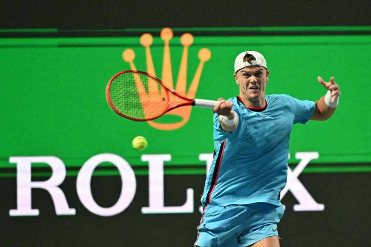 Denmark's Holger Rune hits a return to Germany's Daniel Altmaier during their men's singles match at the Shanghai Masters tennis tournament in Shanghai on October 7, 2026. Hector RETAMAL / AFP