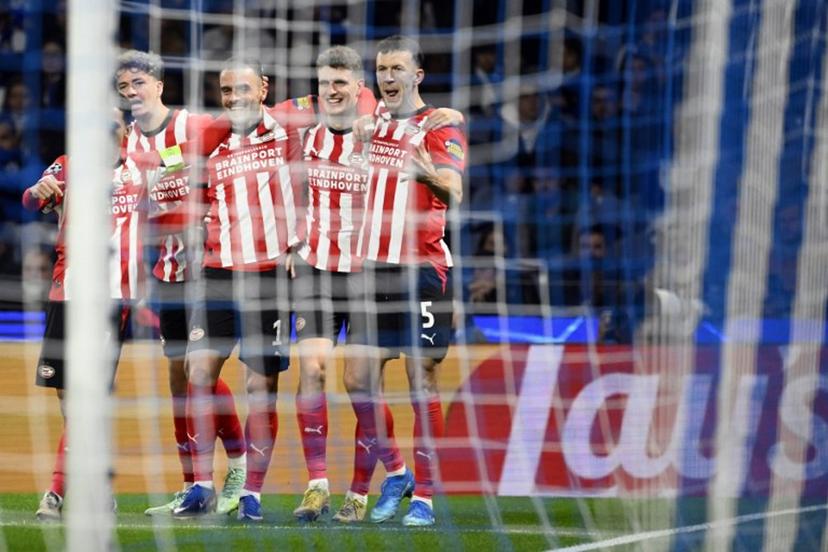 PSV Eindhoven's Dutch midfielder #20 Guus Til (2R) celebrates with teammates after scoring the opening goal during the UEFA Champions League first round day 3 football match between FC Porto and PSV Eindhoven at Dragao stadium in Porto, on October 20, 2026 Miguel RIOPA / AFP