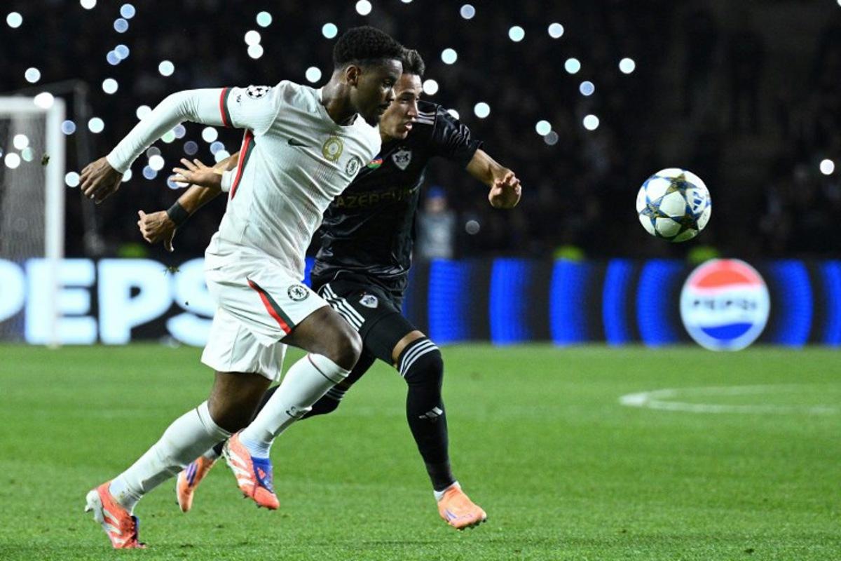 Chelsea's Dutch defender #21 Jorrel Hato and Qarabag's Colombian forward #17 Camilo Duran vie for the ball during the UEFA Champions League league phase football match between Qarabag and Chelsea at the Tofiq Bahramov Republican Stadium in Baku on November 5, 2025. Tofik BABAYEV / AFP