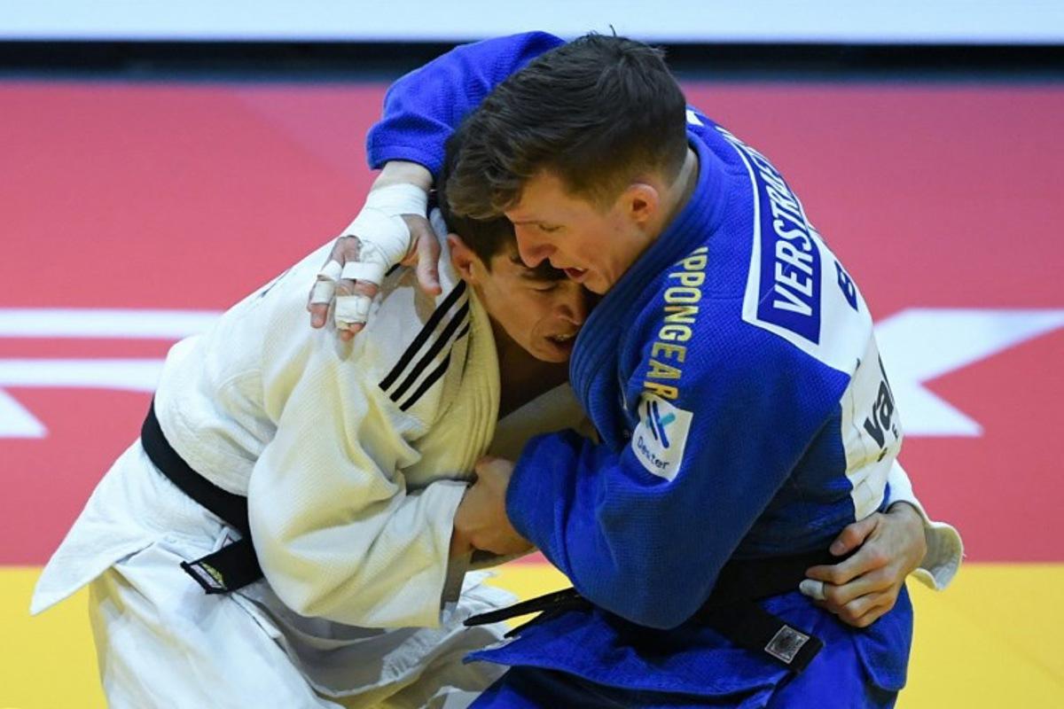 Turkmenistan's Aybek Omirov fights against Belgium's Jorre Verstraeten (blue) in the men's -60kg qualification round bout of the Judo World Championships at the Papp Laszlo Arena in Budapest, Hungary on June 13, 2025. Ferenc ISZA / AFP