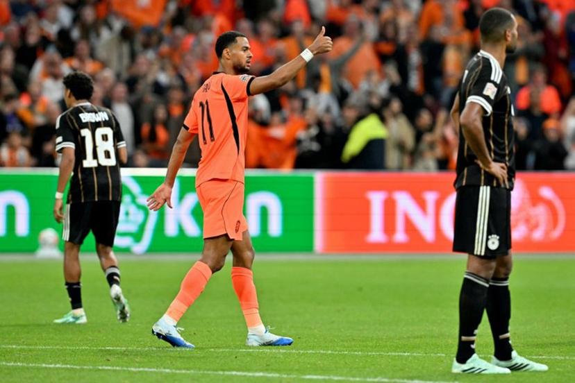 Netherlands' forward #11 Cody Gakpo celebrates after scoring his team's first goal during the UEFA Nations League (League A, Group A2) football match between Netherlands and Germany at Johan Cruijff ArenA in Amsterdam on September 24, 2026. NICOLAS TUCAT / AFP
