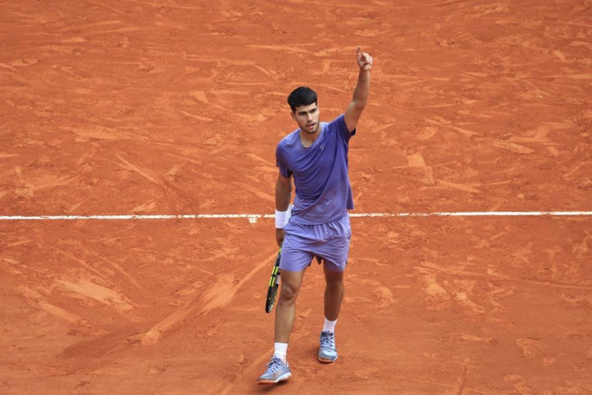 Spain's Carlos Alcaraz reacts after a point as he plays against France's Arthur Fils during the Monte Carlo ATP Masters Series Tournament quarter-final tennis match on the Rainier III court at the Monte Carlo Country Club in Roquebrune-Cap-Martin on April 11, 2025. Valery HACHE / AFP