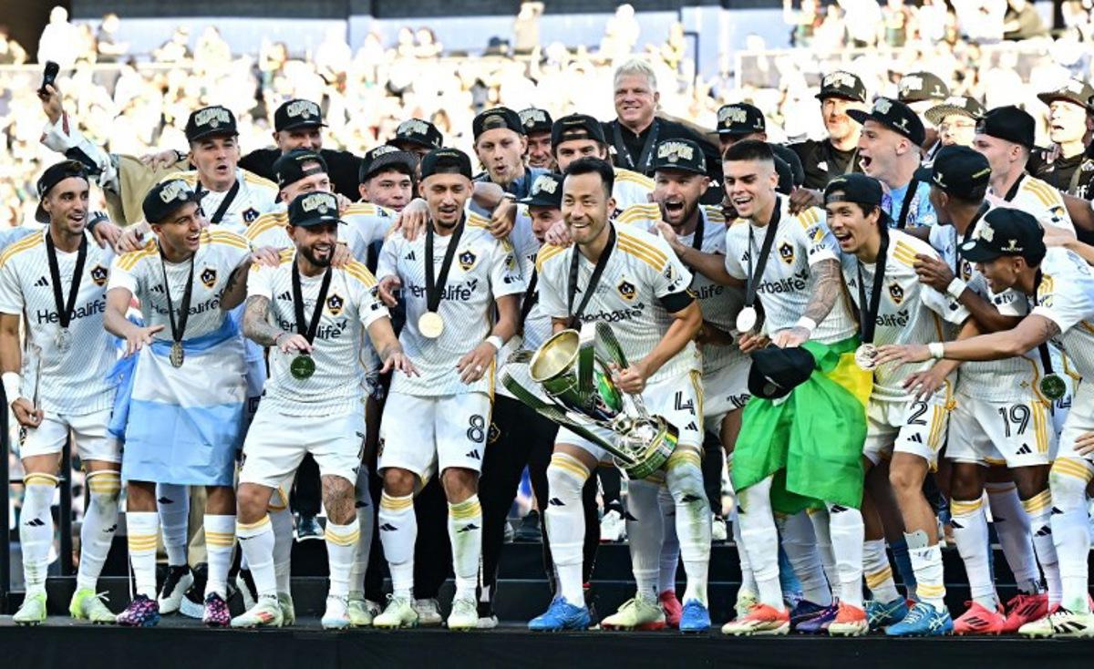 LA Galaxy's captain Japanese defender #04 Maya Yoshida prepares to lift the trophy as he celebrates with teammates following the Major League Soccer (MLS) Cup Final match between the LA Galaxy and the NY Red Bulls at the Dignity Health Sports Park in Carson, California, on December 7, 2024. Frederic J. BROWN / AFP