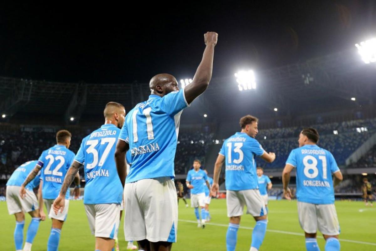 Napoli's Belgian forward #11 Romelu Lukaku (C) celebrates with teammates after scoring a goal during the Italian Serie A football match SSC Napoli vs Genoa CFC at Diego Armando Maradona Stadium in Naples, on May 11, 2025. CARLO HERMANN / AFP