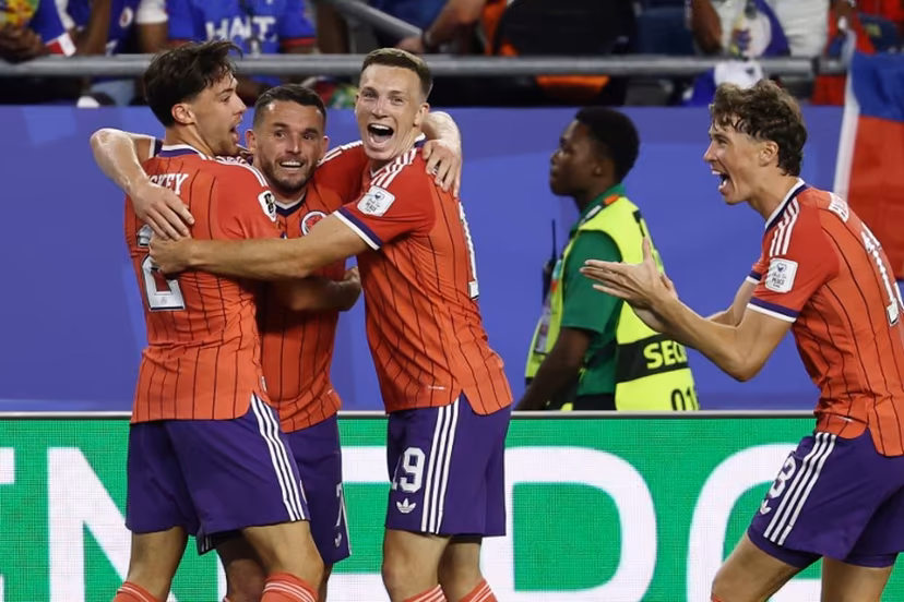 Scotland's midfielder #07 John McGinn (2nd L) celebrates with teammates after scoring his team's first goal during the 2026 World Cup Group C football match between Haiti and Scotland at the Boston Stadium in Foxborough on June 13, 2026. FRANCK FIFE / AFP
