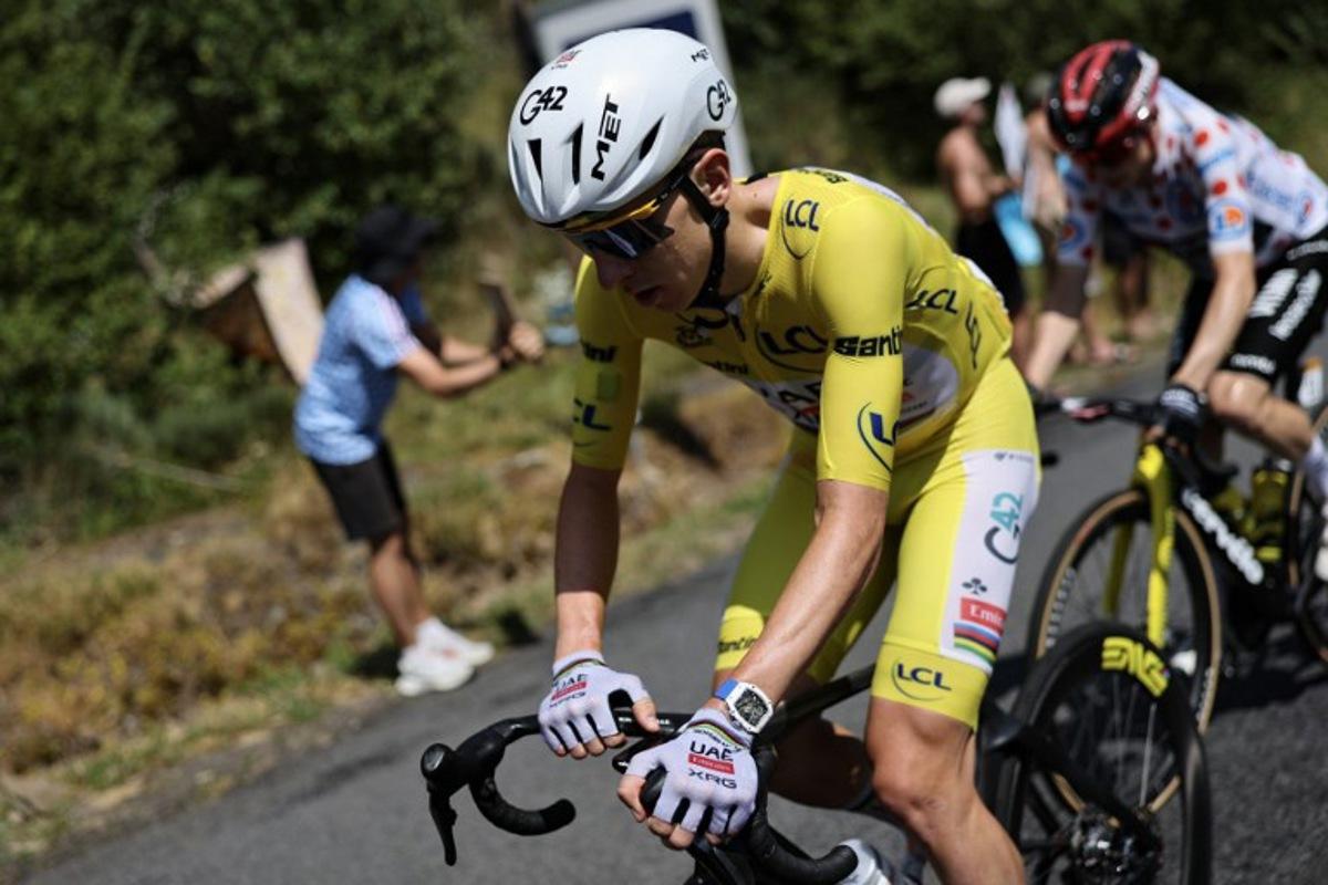 UAE Team Emirates - XRG's Slovenian rider Tadej Pogacar wearing the overall leader's yellow jersey cycles during the 10th stage of the 113th edition of the Tour de France cycling race, 166,6 km between Aurillac and Le Lioran in the Massif Central, on July 14, 2026. Anne-Christine POUJOULAT / AFP