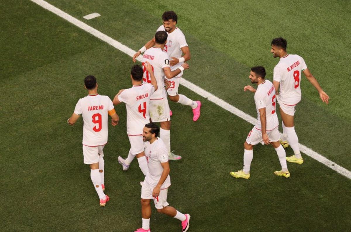 Iran's defender #23 Ramin Rezaeian celebrates with teammates after scoring his team's first goal during the 2026 World Cup Group G football match between Iran and New Zealand at Los Angeles Stadium in Inglewood on June 15, 2026. Etienne Laurent / AFP