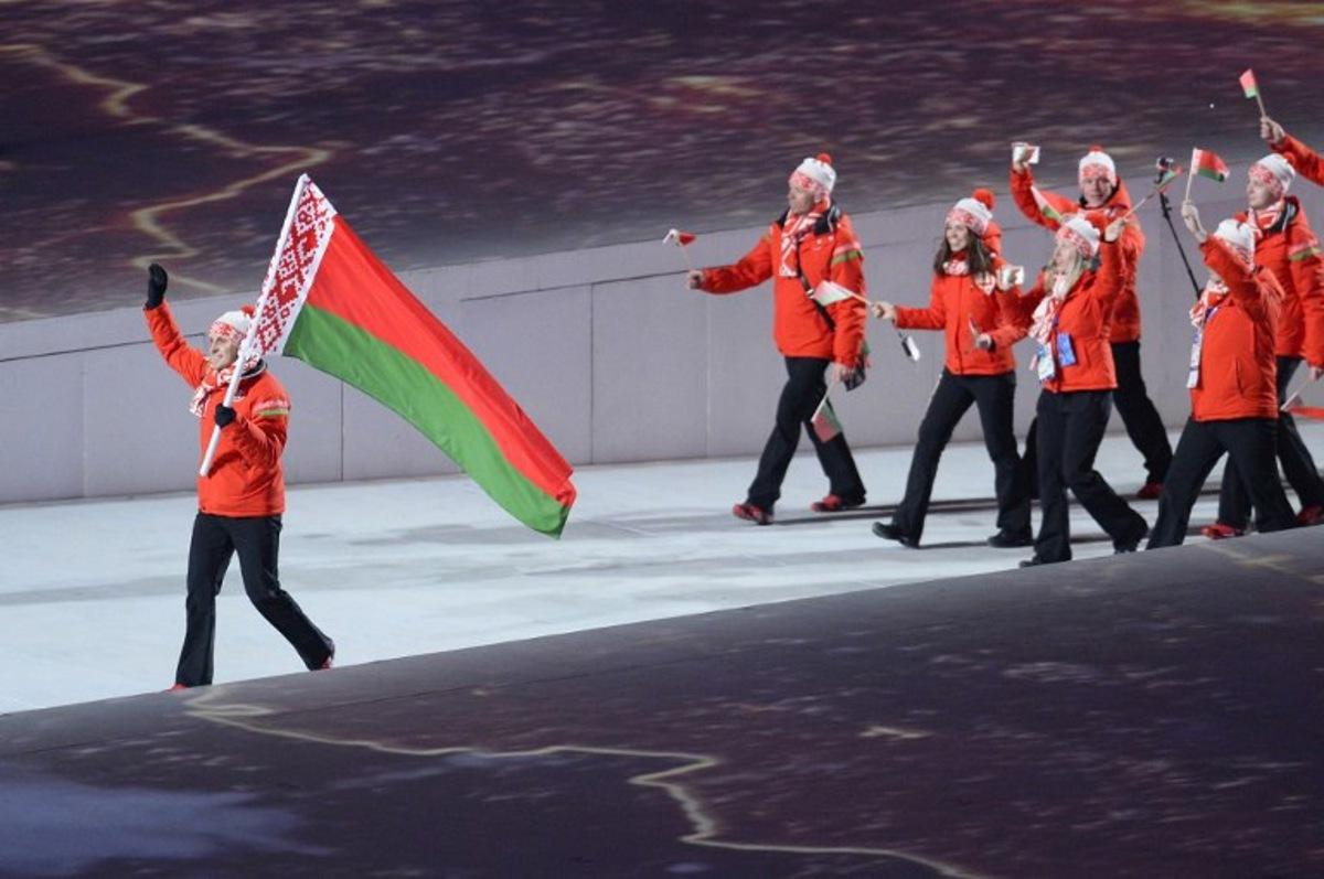 Belarus' flag bearer, freestyle skier Aleksei Grishin leads his national delegation during the Opening Ceremony of the Sochi Winter Olympics at the Fisht Olympic Stadium on February 7, 2014 in Sochi. AFP PHOTO / JONATHAN NACKSTRAND Jonathan NACKSTRAND / AFP
