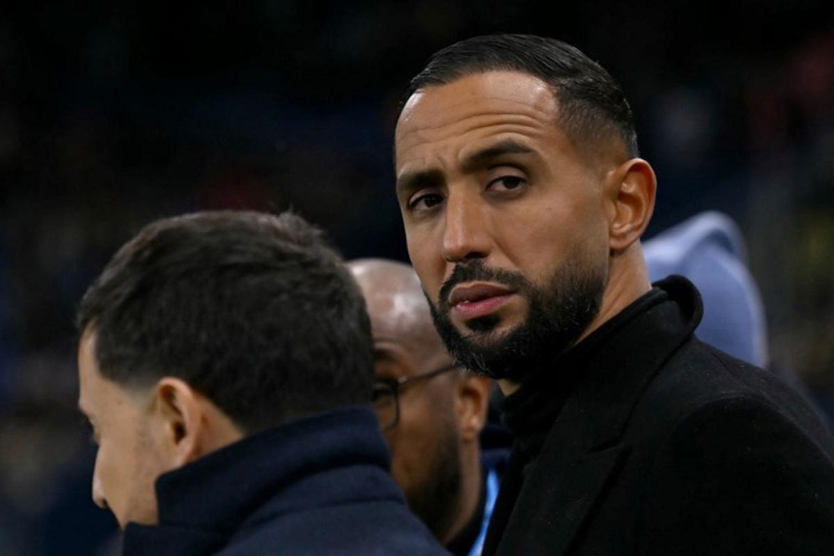 Marseille's French-Moroccan sporting director Medhi Benatia (R) looks on ahead of the French Cup round of 32 football match between FC Bayeux and Olympique de Marseille (OM) at the Michel-d'Ornano Stadium in Caen on January 13, 2026. LOU BENOIST / AFP