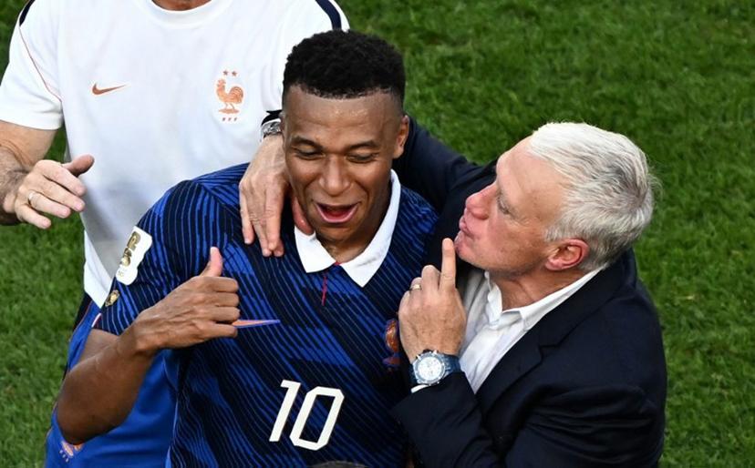 France's forward #10 Kylian Mbappe celebrates with his coach Didier Deschamps after winning the 2026 World Cup round of 16 football match between Paraguay and France at the Philadelphia Stadium in Philadelphia on July 4, 2026. Jewel SAMAD / AFP