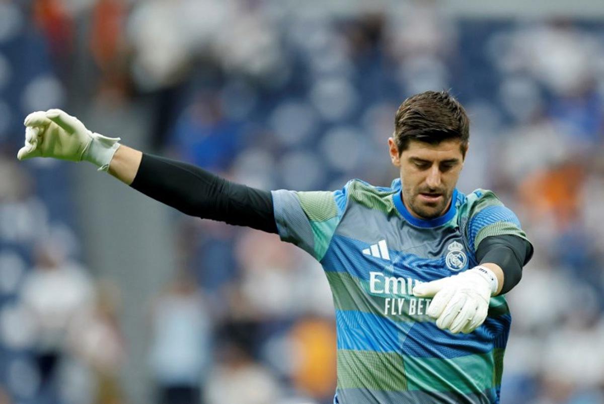 Real Madrid's Belgian goalkeeper #01 Thibaut Courtois warms up prior the Spanish league football match between Real Madrid CF and RCD Espanyol at the Santiago Bernabeu stadium in Madrid on September 20, 2025. Oscar DEL POZO / AFP