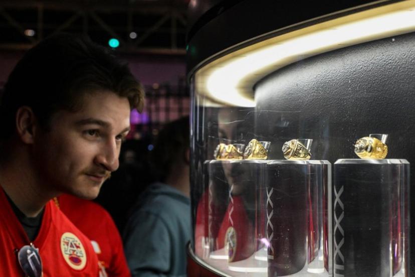 A man looks at a display of super bowl rings at the "A New Era of Immersive NFL Fan Engagement" ahead of Super Bowl LIX, where the Kansas City Chiefs will play the Philadelphia Eagles, in New Orleans, Louisiana, on February 8, 2025. CHANDAN KHANNA / AFP