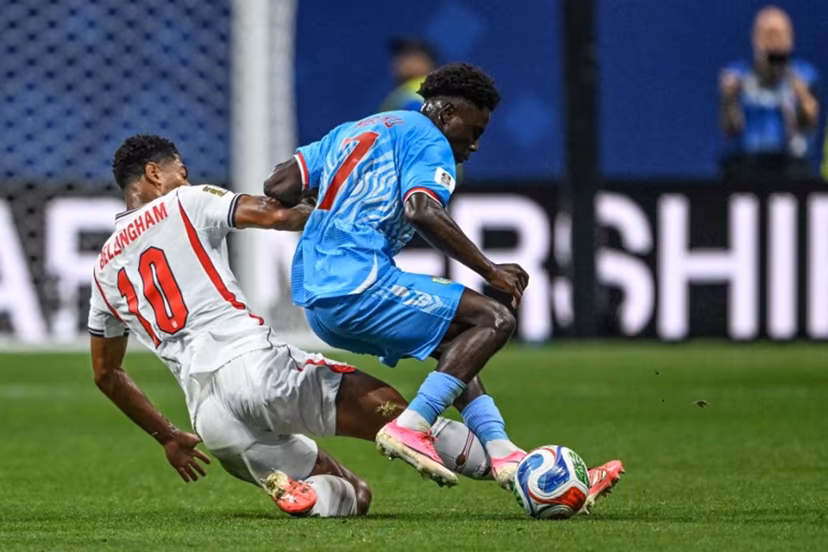 England's midfielder #10 Jude Bellingham and Congo DR's midfielder #07 Nathanael Mbuku fight for the ball during the 2026 World Cup round of 32 match football between England and the Democratic Republic of Congo at the Atlanta Stadium in Atlanta on July 1, 2026. ROBERTO SCHMIDT / AFP
