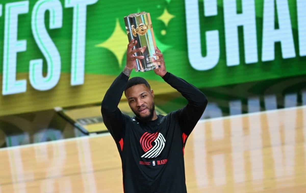 Basketball player Damian Lillard, of the Portland Trailblazers, holds up the trophy after winning the three point contest during NBA All-Star Weekend in Salt Lake City, Utah, February 18, 2023. Patrick T. Fallon / AFP