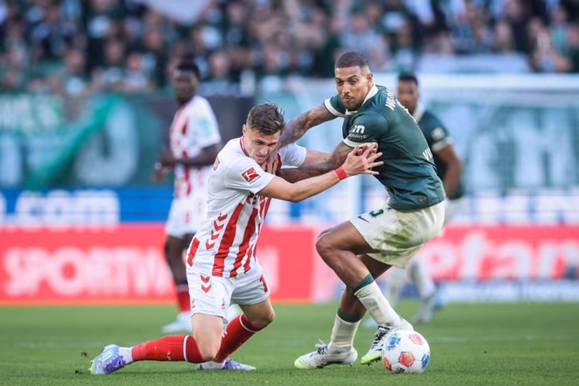 Wolfsburg's Brazilian midfielder #05 Vinicius Souza (R) and FC Cologne's Belgian-Spanish midfielder #17 Alessio Castro-Montes vie for the ball during the German first division Bundesliga football match between VfL Wolfsburg and FC Cologne in Wolfsburg, northern Germany, on September 13, 2025. Ronny Hartmann / AFP