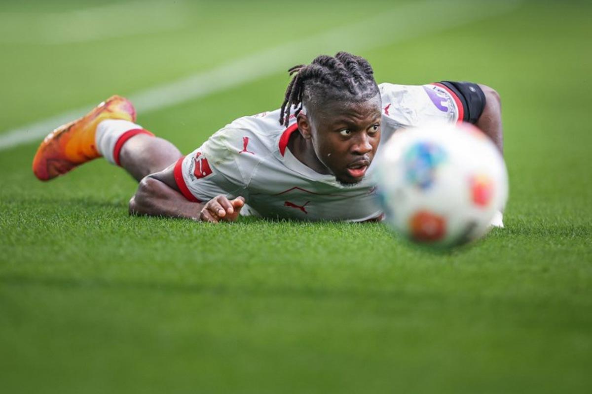 Leipzig's Belgian forward #09 Johan Bakayoko is lying on the pitch during the German first division Bundesliga football match between VfL Wolfsburg and RB Leipzig in Wolfsburg, northern Germany on September 27, 2025. RONNY HARTMANN / AFP