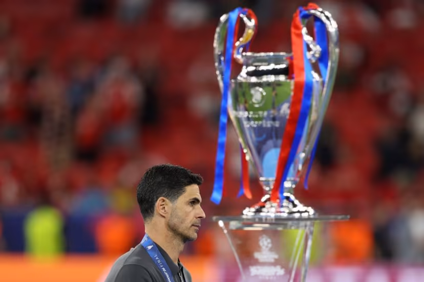 Arsenal's Spanish manager Mikel Arteta walks past the trophy following the UEFA Champions League final football match between Paris Saint-Germain (PSG) and Arsenal FC at the Puskas Arena in Budapest on May 30, 2026. Odd ANDERSEN / AFP