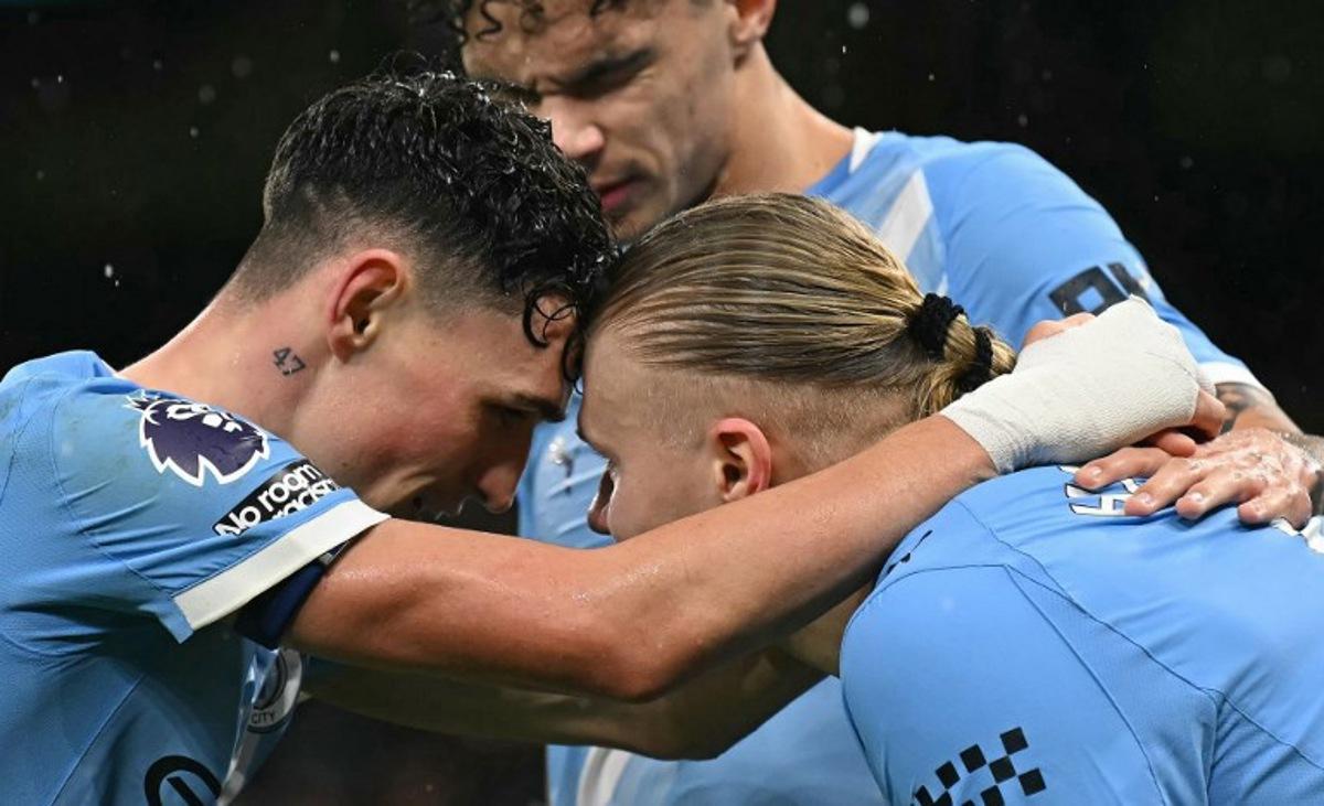 Manchester City's Norwegian striker #09 Erling Haaland (R) celebrates scoring the team's third goal with Manchester City's English midfielder #47 Phil Foden and Manchester City's English midfielder #33 Nico O'Reilly during the English Premier League football match between Manchester City and Fulham at the Etihad Stadium in Manchester, north west England, on February 11, 2026. Paul ELLIS / AFP