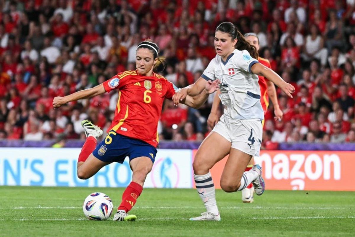 Spain's midfielder #06 Aitana Bonmati fights for the ball with Switzerland's midfielder #04 Noemi Ivelj during the UEFA Women's Euro 2025 quarter finals football match between Spain and Switzerland at the Wankdorf stadium in Bern, northwestern Switzerland on July 18, 2025. SEBASTIEN BOZON / AFP