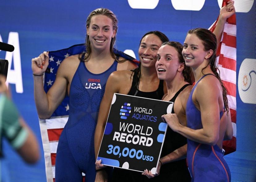 Team USA US' swimmer Gretchen Walsh, US' swimmer Torri Huske, US' swimmer Regan Smith and US' swimmer Kate Douglass pose after winning the final of the women's 4x100m medley relay swimming event during the 2025 World Aquatics Championships in Singapore on August 3, 2025. Oli SCARFF / AFP