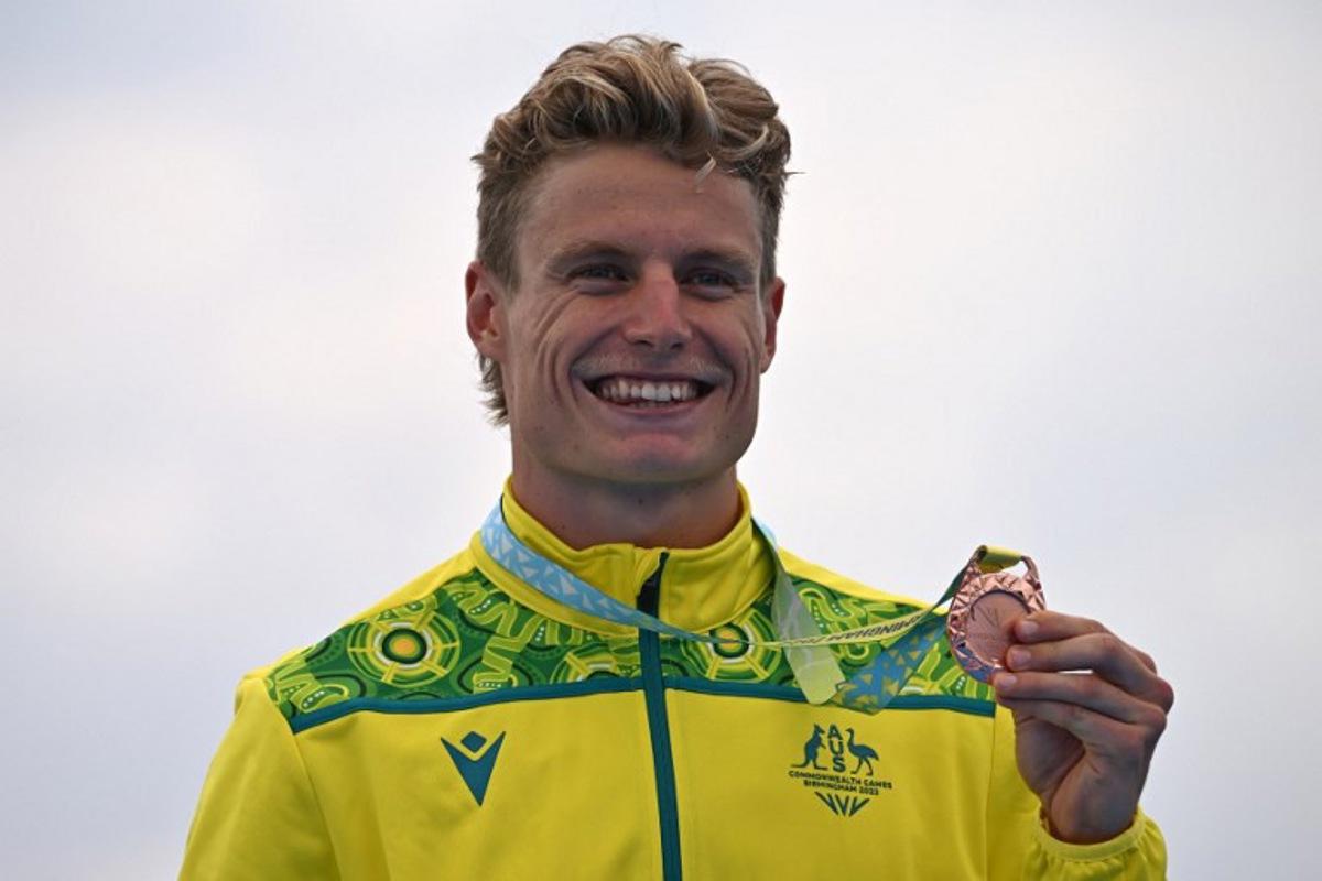 Bronze medallist Australia's Matthew Hauser poses with his medal during the medal presentation ceremony for the Men's Individual Sprint Distance Triathlon event on day one of the Commonwealth Games at Sutton Park in Sutton Coldfield, central England, on July 29, 2022. Ben Stansall / AFP