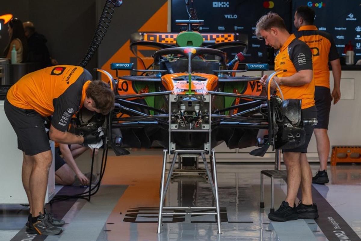 Mechanics work on the car of McLaren's Australian driver Oscar Piastri at the Lusail International Circuit ahead of the Formula One Qatar Grand Prix in Lusail on November 27, 2025. Andrej ISAKOVIC / AFP