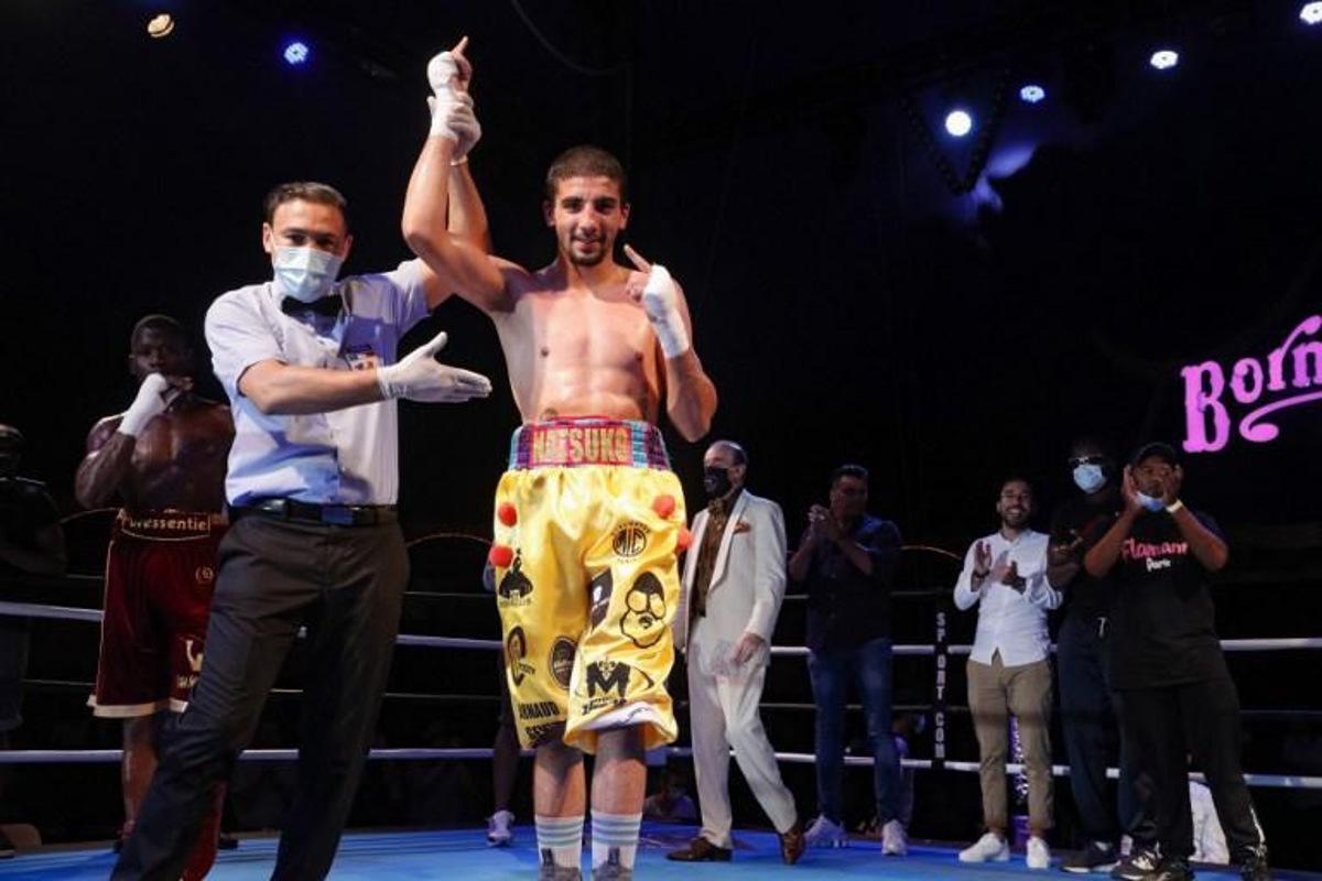 French boxer Milan Prat (C) celebrates after winning his fight against French boxer Jonathan Okito (L) during the Fighting Nation box evening, the first post covid indoor event, inside the Bormann circus in Paris, on July 30, 2020. GEOFFROY VAN DER HASSELT / AFP TO GO WITH AFP STORY by Clement VARANGES