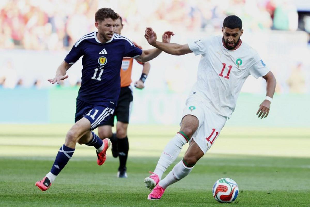 Morocco's midfielder #11 Ismael Saibari (R) and Scotland's forward #11 Ryan Christie fight for the ball during the 2026 World Cup Group C football match between Scotland and Morocco at the Boston Stadium in Foxborough on June 19, 2026. FRANCK FIFE / AFP