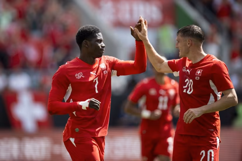Switzerland's forward #7 Breel Embolo (L) celebrates with Switzerland's midfielder #20 Michel Aebischer scoring his team's first goal during a friendly football match between Switzerland and Jordan ahead of the 2026 FIFA World Cup football tournament at the Kybunpark stadium in St. Gallen on May 31, 2026. Ennio LEANZA / AFP