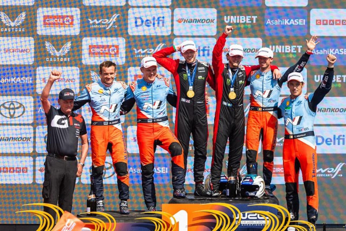 Winners Swedish Oliver Solberg (C-R) and his British co-driver Elliott Edmondson (C-L), second placed Estonian driver Ott Tanak (3rd L) and co-driver Martin Jarveoja (2nd L) and third placed Belgium driver Thierry Neuville (R) and co-driver Martijn Wydaeghe (2nd R) celebrate on the podium after winning the Rally Estonia, the eighth round of the FIA World Rally Championship, on July 20, 2025 in Kaariku, Estonia. TIMO ANIS / AFP