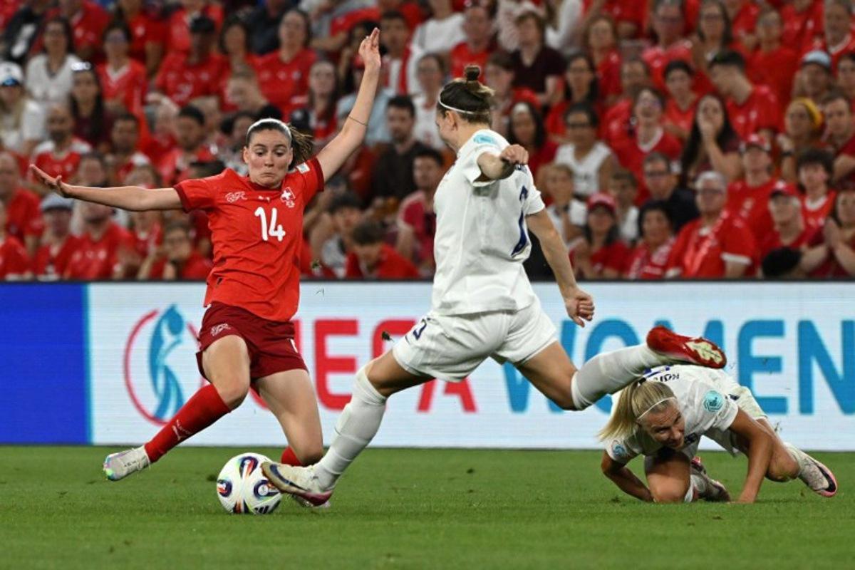 Switzerland's midfielder #14 Smilla Vallotto and Finland's defender #15 Natalia Kuikka fight for the ball during the UEFA Women's Euro 2025 Group A football match between Finland and Switzerland at the Stade de Geneve in Geneva, on July 10, 2025. Miguel MEDINA / AFP