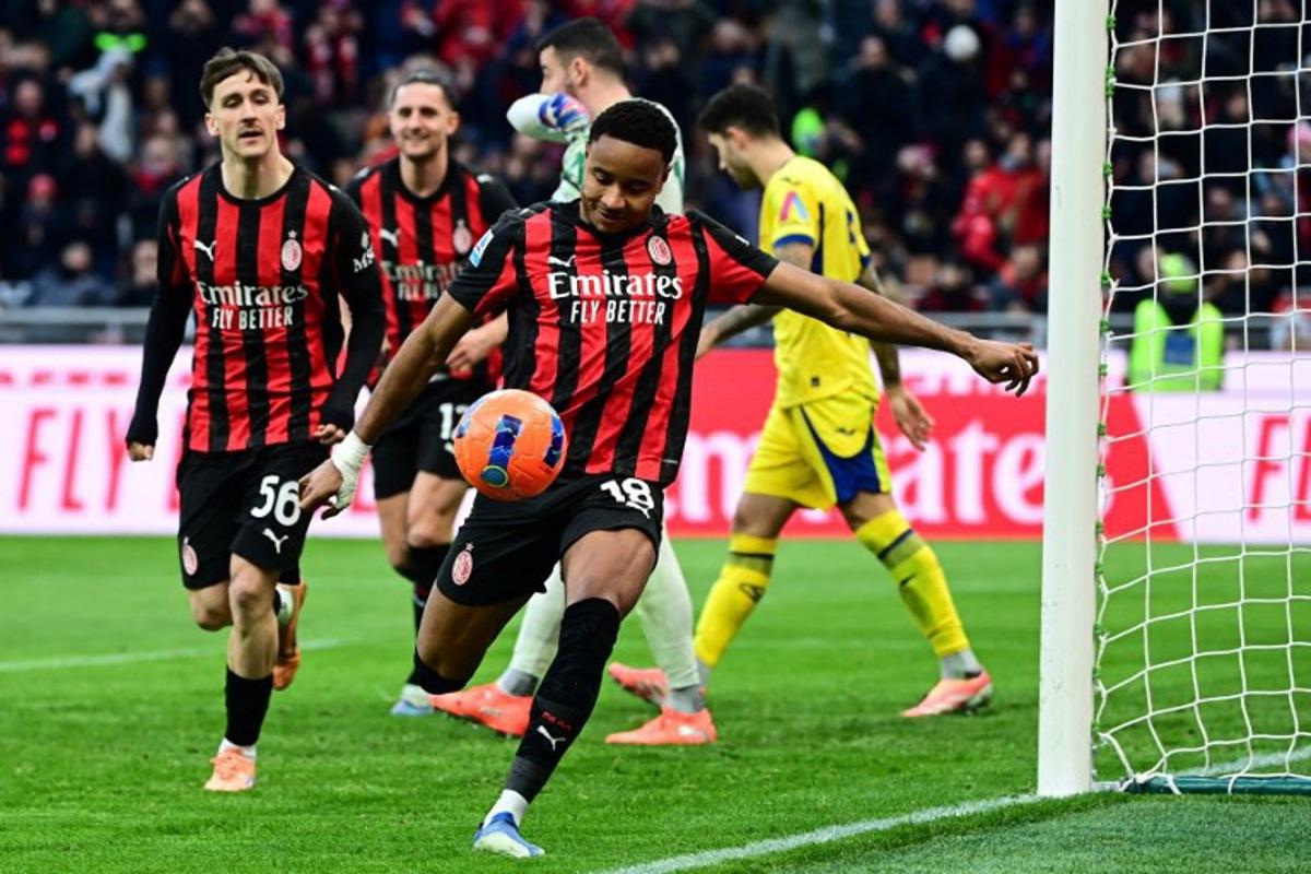 AC Milan's French forward #18 Christopher Nkunku (C) celebrates after scoring his team second goal during the Italian Serie A football match between AC Milan and Hellas Verona at the San Siro stadium in Milan, northern Italy, on December 28, 2025. Piero CRUCIATTI / AFP