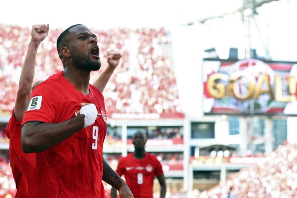 Canada's forward #09 Cyle Larin (R) celebrates after scoring a goal during the 2026 World Cup Group B football match between Canada and Bosnia and Herzegovina at the Toronto Stadium in Toronto on June 12, 2026. Cole Burston / AFP