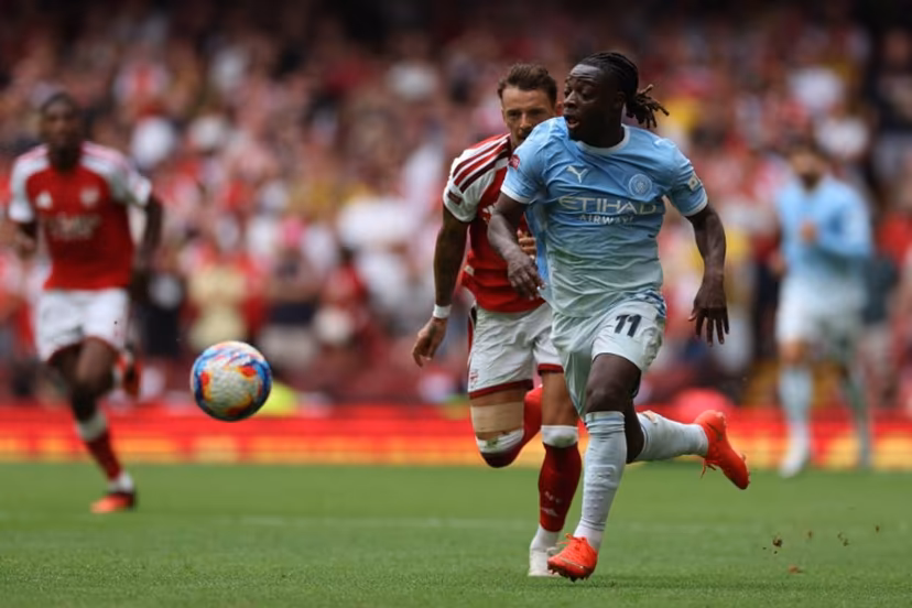 Manchester City's Belgian midfielder #11 Jeremy Doku runs with the ball during the English FA Community Shield football match between Arsenal and Manchester City at The Principality Stadium, in Cardiff, south Wales on August 16, 2026. Adrian Dennis / AFP