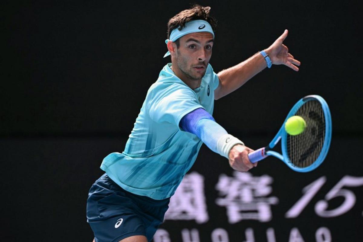 Italy's Lorenzo Musetti hits a return to Serbia's Novak Djokovic during their men's singles quarter-final match on day eleven of the Australian Open tennis tournament in Melbourne on January 28, 2026. WILLIAM WEST / AFP