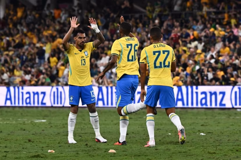 Brazil's Rayan Vitor Simplício Rocha (C) celebrates with Brazil's Matheuzinho (L) after scoring a goal during the International friendly football match between Australia and Brazil at Queensland Country Bank Stadium in Townsville on September 25, 2026. SAEED KHAN / AFP