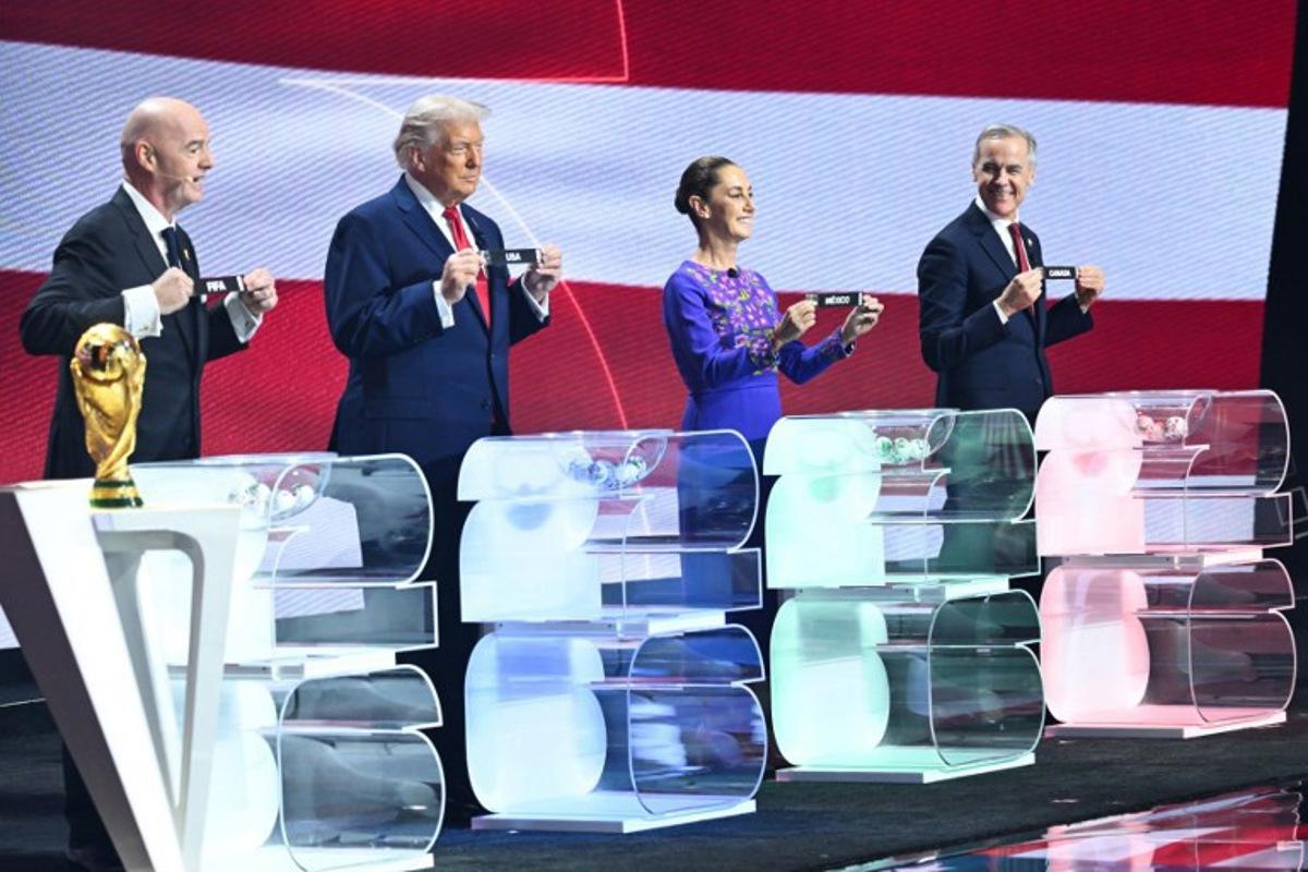 (From L) FIFA President Gianni Infantino, US President Donald Trump, Mexico's President Claudia Sheinbaum and Canada's Prime Minister Mark Carney pose with their cards during the draw for the 2026 FIFA Football World Cup taking place in the US, Canada and Mexico, at the Kennedy Center, in Washington, DC, on December 5, 2025. SAUL LOEB / AFP
