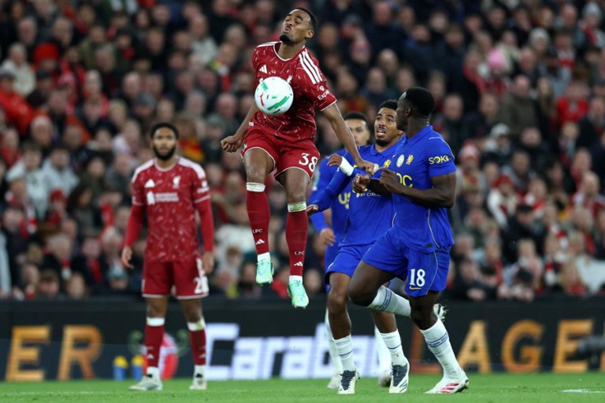 Liverpool's Dutch midfielder #38 Ryan Gravenberch controls the ball whilst under pressure from Chelsea's English striker #18 Danny Welbeck during the English League Cup fourth round football match between Liverpool and Chelsea at Anfield in Liverpool, north west England on October 28, 2026. Darren Staples / AFP