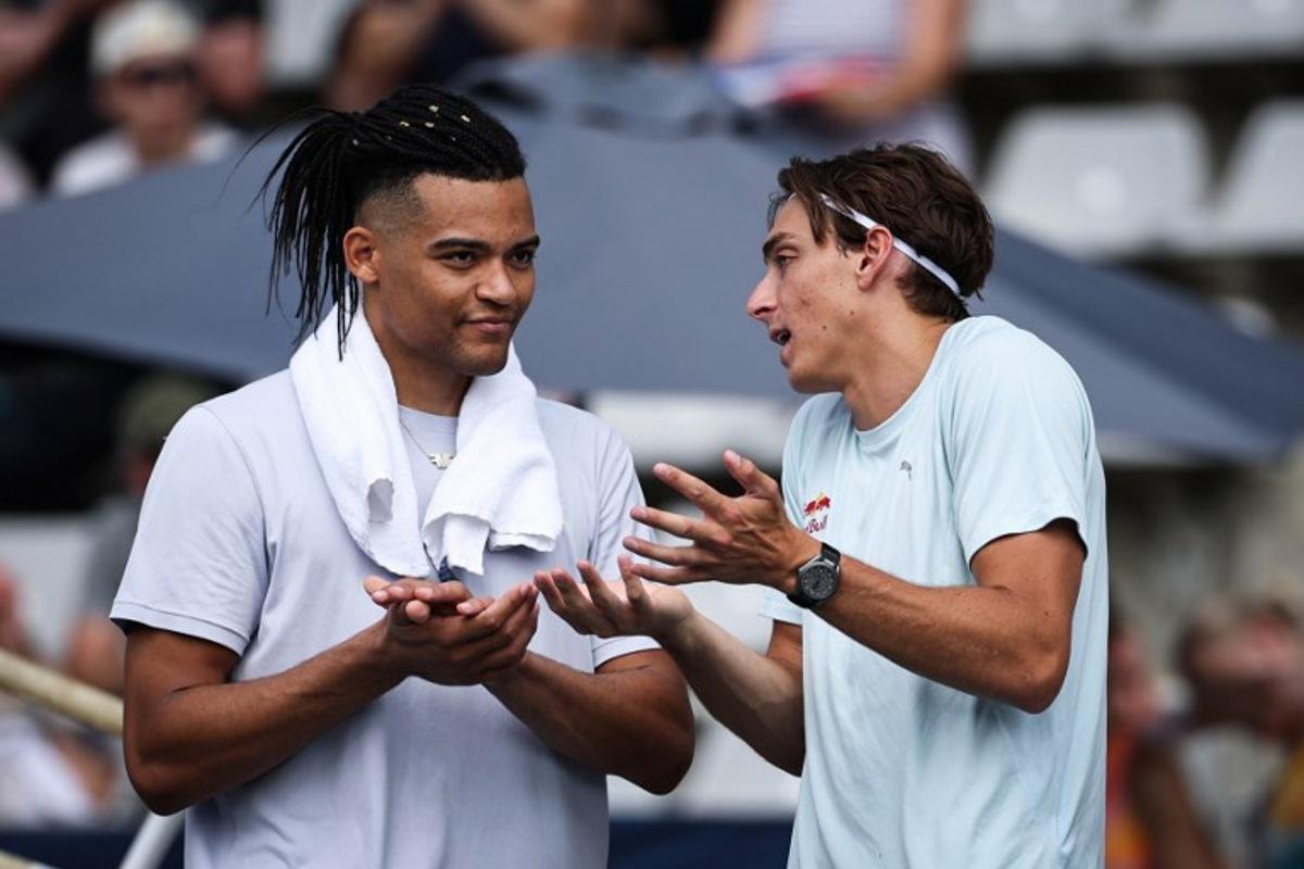 Greece's Emmanouil Karalis (L) and Sweden's Armand Duplantis speaks together prior to compete in the men's Pole Vault during the IAAF Diamond League athletics meeting, at the Charlety Stadium, in Paris on June 28, 2026. Anne-Christine POUJOULAT / AFP