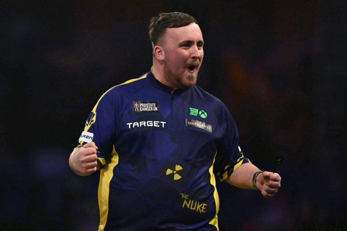England's Luke Littler celebrates winning the fourth set against Netherlands' Michael van Gerwen during the PDC World Darts Championship final, at Alexandra Palace in London on January 3, 2025. Ben STANSALL / AFP