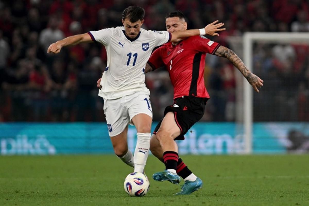 Serbia's midfielder #11 Lazar Vujadin Samardzic (L) and Albania's forward #07 Rey Manaj fight for the ball during the 2026 World Cup qualifiers Europe zone, 1st round group K football match between Albania and Serbia at the Air Albania Stadium in Tirana on June 7, 2025. Armend NIMANI / AFP