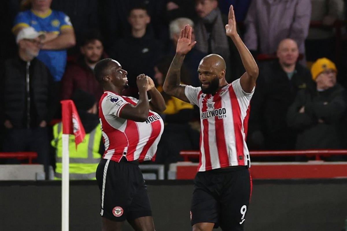 Brentford's Italian defender #33 Michael Kayode (L) celebrates with Brentford's Brazilian striker #09 Igor Thiago (R) after scoring the opening goal during the English Premier League football match between Brentford and Wolverhampton Wanderers at the Gtech Community Stadium in London on March 16, 2026. Adrian Dennis / AFP
