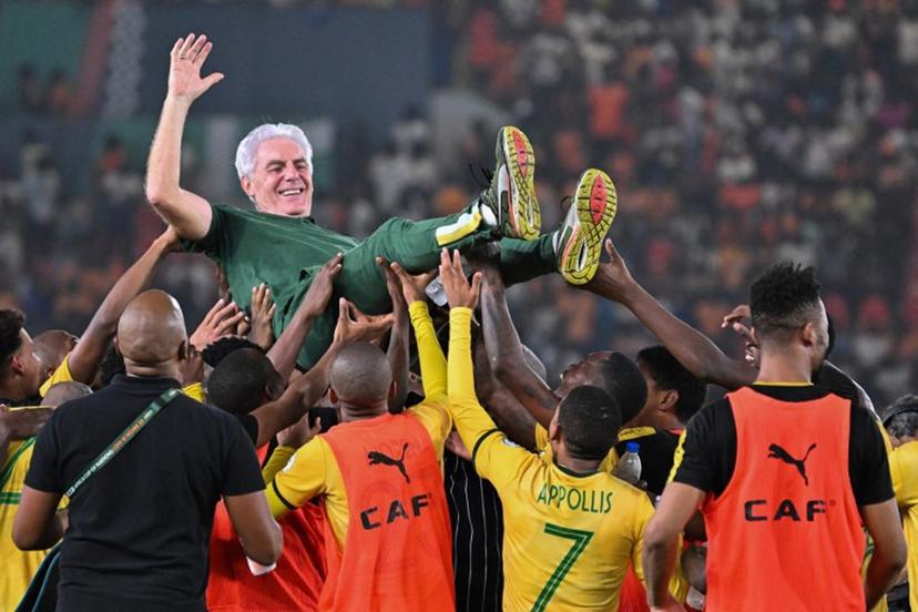 South Africa's head coach Hugo Broos is lifted in the air by South African players after they won the Africa Cup of Nations (CAN) 2024 third place play-off football match between South Africa and Democratic Republic of Congo at Felix Houphouet-Boigny Stadium in Abidjan on February 10, 2024. Sia KAMBOU / AFP