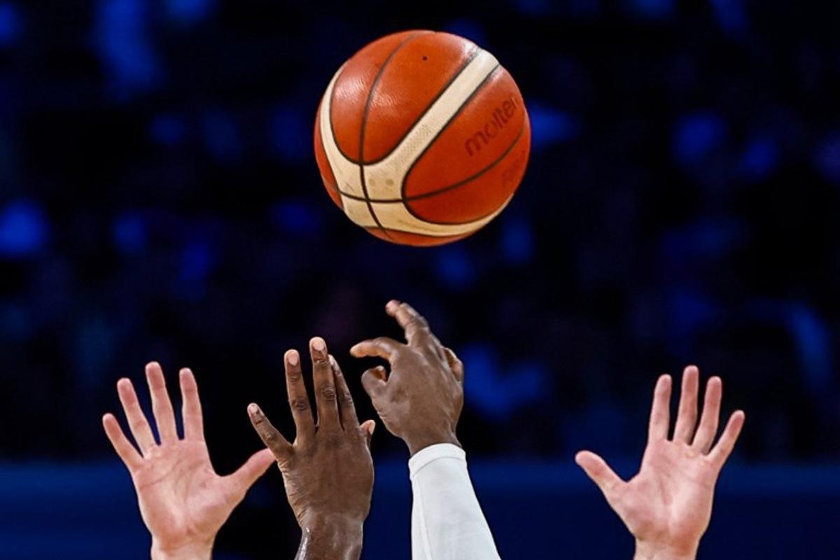 Players jump for the ball in the men's preliminary round group A basketball match between Canada and Australia during the Paris 2024 Olympic Games at the Pierre-Mauroy stadium in Villeneuve-d'Ascq, northern France, on July 30, 2024. Sameer Al-Doumy / AFP